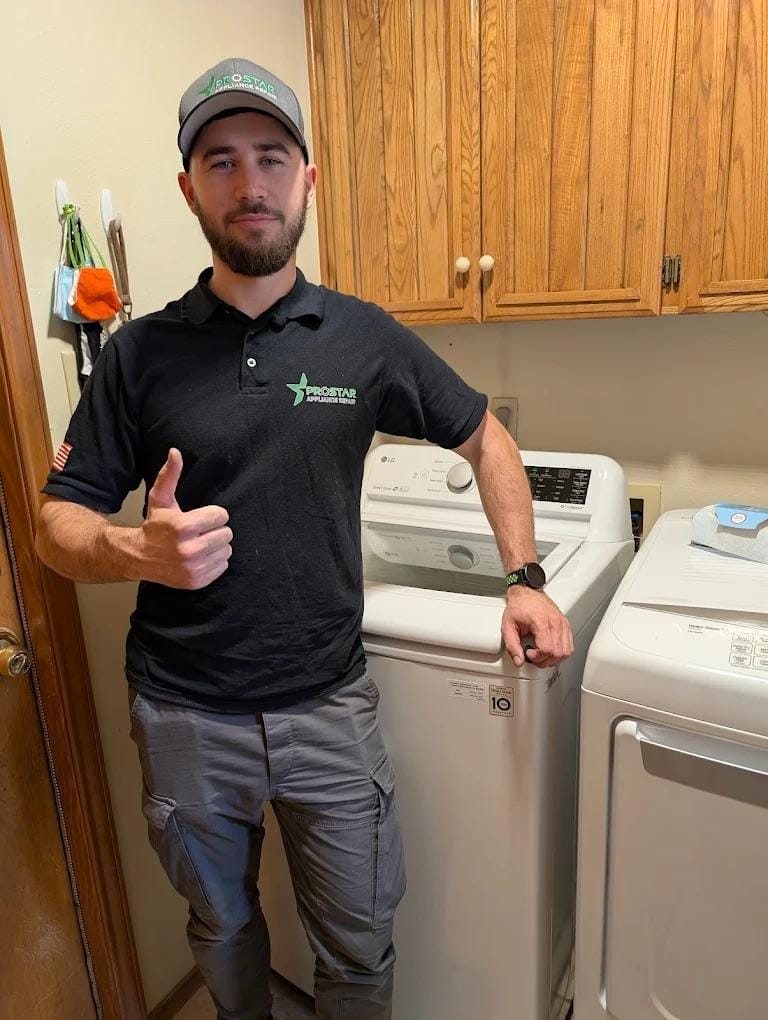 ### Main Subjects
- Technician in a work uniform
- Washing machine and dryer### Notable Features
- Technician giving a thumbs-up gesture
- Clean and organized laundry room
- Wooden cabinetry in the background### Text/Symbols
- Logo on the technician's shirt
- American flag patch on the sleeve### Overall Mood/Theme
The image conveys a positive and professional atmosphere, highlighting customer satisfaction and reliability in home appliance service. The technician's thumbs-up suggests confidence and approval of the work done.