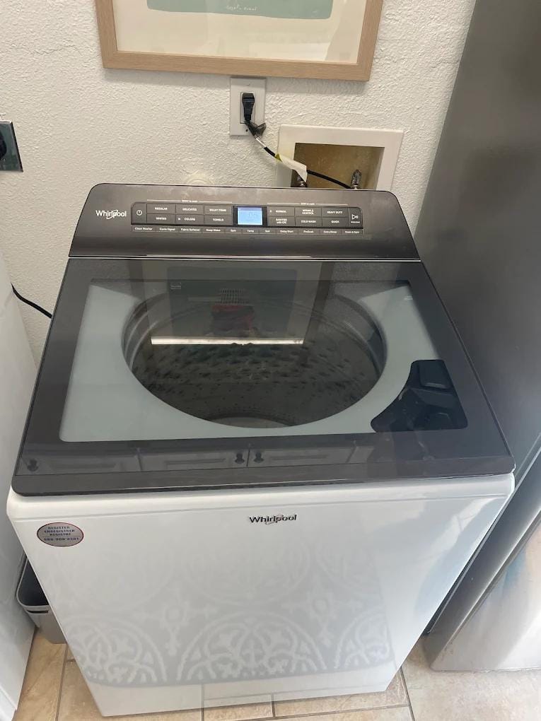 Technician repairing refrigerator in modern kitchen emphasizing same-day repair benefits