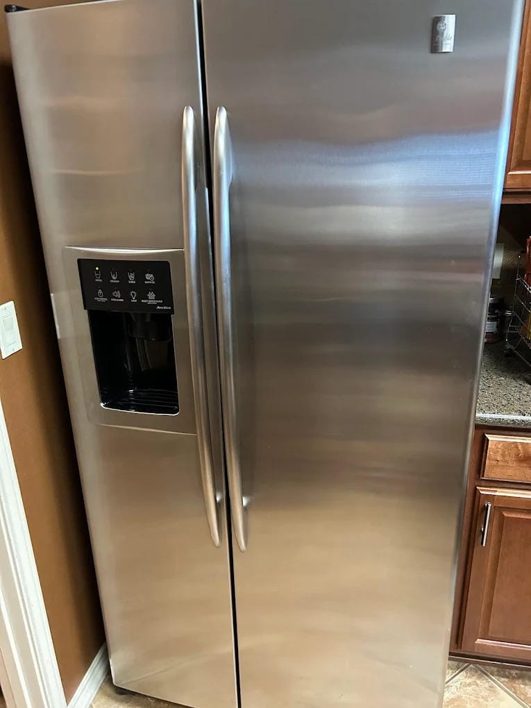 ### Main Subject - Stainless Steel Refrigerator ### Notable Features - Side-by-side door design -